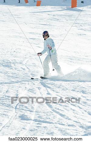 Teenage girl skiing down ski slope, full length View Large Photo Image Stock Photography - Teenage girl skiing down ski slope, full length. Fotosearch