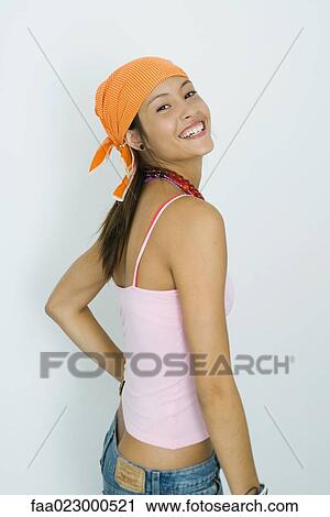 Teenage girl smiling at camera, hand on hip, portrait View Large Photo Image Stock Image - Teenage girl smiling at camera, hand on hip, portrait. Fotosearch