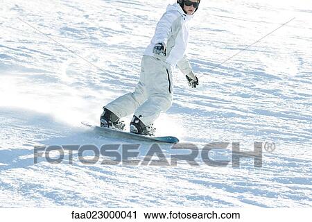 Teenage girl snowboarding down ski slope, cropped view View Large Photo Image Stock Image - Teenage girl snowboarding down ski slope, cropped view. Fotosearch
