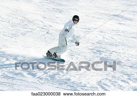 Teenage girl snowboarding down ski slope, full length View Large Photo Image Stock Photo - Teenage girl snowboarding down ski slope, full length. Fotosearch