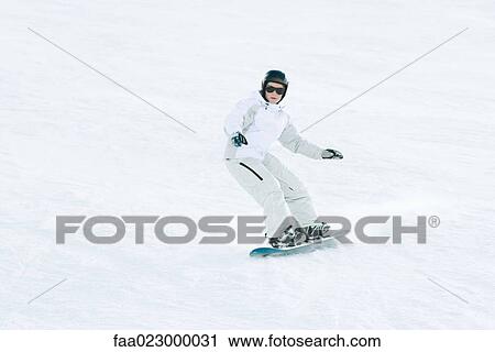 Teenage girl snowboarding on ski slope, full length View Large Photo Image Stock Image - Teenage girl snowboarding on ski slope, full length. Fotosearch