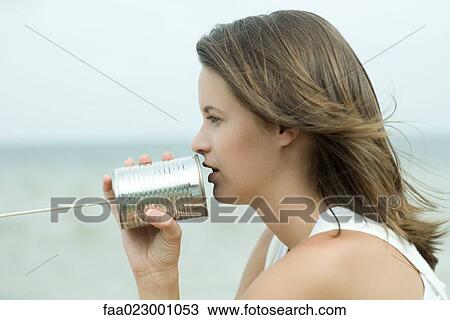 Teenage girl talking into tin can phone, side view, close-up View Large Photo Image Stock Image - Teenage girl talking into tin can phone, side view, close-up. Fotosearch