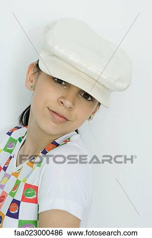 Teenage girl wearing cap, smiling at camera, portrait View Large Photo Image Stock Photograph - Teenage girl wearing cap, smiling at camera, portrait. Fotosearch