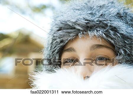 Stock Image - Teenage girl wearing fur hat and fur collar, close-up portrait. Fotosearch