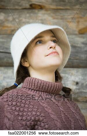 Teenage girl wearing hat and turtleneck, looking up, portrait View Large Photo Image Stock Photograph - Teenage girl wearing hat and turtleneck, looking up, portrait. Fotosearch