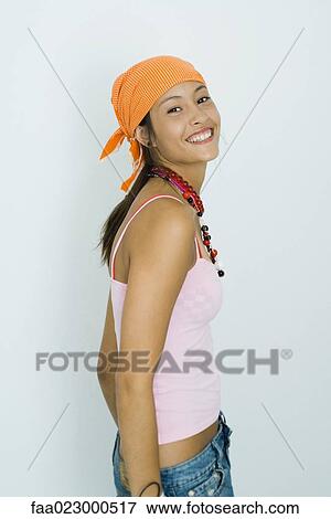 Teenage girl wearing headscarf, smiling at camera, portrait View Large Photo Image Stock Photo - Teenage girl wearing headscarf, smiling at camera, portrait. Fotosearch