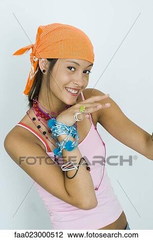 Teenage girl wearing lots of jewelry, smiling at camera, portrait View Large Photo Image Stock Image - Teenage girl wearing lots of jewelry, smiling at camera, portrait. Fotosearch