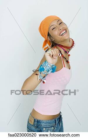 Teenage girl wearing lots of jewelry, smiling at camera, portrait View Large Photo Image Stock Image - Teenage girl wearing lots of jewelry, smiling at camera, portrait. Fotosearch