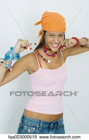 Teenage girl wearing lots of jewelry, smiling at camera, portrait View Large Photo Image Stock Photo - Teenage girl wearing lots of jewelry, smiling at camera, portrait. Fotosearch