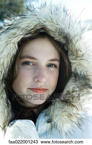 Stock Image - Teenage girl wearing parka, close-up portrait. Fotosearch