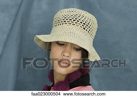 Teenage girl wearing sun hat, looking down, portrait View Large Photo Image Picture - Teenage girl wearing sun hat, looking down, portrait. Fotosearch