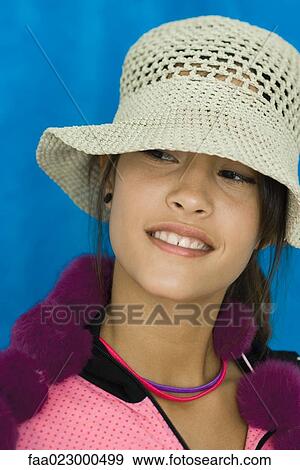 Teenage girl wearing sun hat, looking away, portrait View Large Photo Image Stock Photo - Teenage girl wearing sun hat, looking away, portrait. Fotosearch