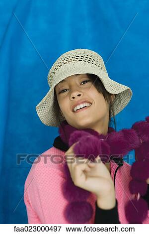 Teenage girl wearing sun hat, smiling at camera, portrait View Large Photo Image Stock Photo - Teenage girl wearing sun hat, smiling at camera, portrait. Fotosearch