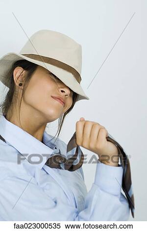 Teenage girl wearing tie and hat, smiling at camera, portrait View Large Photo Image Stock Photography - Teenage girl wearing tie and hat, smiling at camera, portrait. Fotosearch