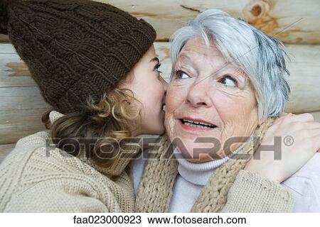 Teenage girl whispering into grandmother's ear, portrait View Large Photo Image Stock Image - Teenage girl whispering into grandmother's ear, portrait. Fotosearch