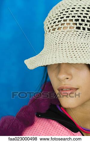 Teenage girl with hat pulled down over eyes, portrait View Large Photo Image Stock Photo - Teenage girl with hat pulled down over eyes, portrait. Fotosearch