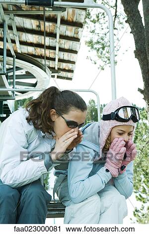 Teenage girls sitting on chair lift together, leaning over, shouting View Large Photo Image Stock Image - Teenage girls sitting on chair lift together, leaning over, shouting. Fotosearch