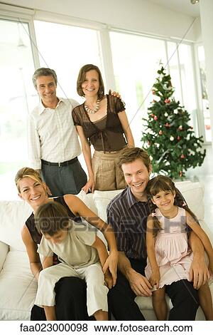 Three generation family, group portrait in front of Christmas tree View Large Photo Image Stock Photo - Three generation family, group portrait in front of Christmas tree. Fotosearch