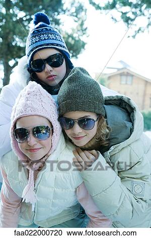 Three teen girls wearing winter clothes and sunglasses, portrait View Large Photo Image Stock Image - Three teen girls wearing winter clothes and sunglasses, portrait. Fotosearch