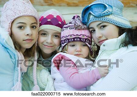 Three teen or preteen girls with toddler, all wearing winter coats and hats, portrait View Large Photo Image Stock Photography - Three teen or preteen girls with toddler, all wearing winter coats and hats, portrait. Fotosearch