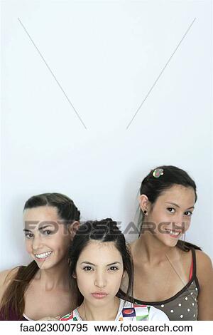 Three young female friends looking at camera, head and shoulders, portrait View Large Photo Image Stock Photography - Three young female friends looking at camera, head and shoulders, portrait. Fotosearch