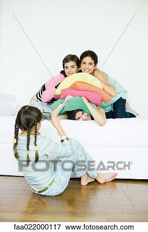 Three young female friends posing while fourth friend takes photo View Large Photo Image Stock Photo - Three young female friends posing while fourth friend takes photo. Fotosearch