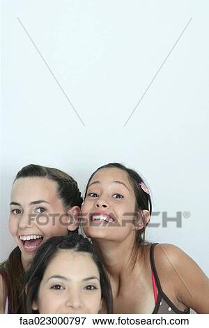 Three young female friends smiling at camera, head and shoulders, portrait View Large Photo Image Stock Photo - Three young female friends smiling at camera, head and shoulders, portrait. Fotosearch