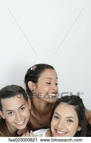 Three young female friends smiling, head and shoulders, portrait View Large Photo Image Stock Image - Three young female friends smiling, head and shoulders, portrait. Fotosearch