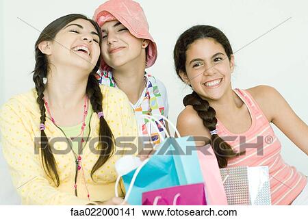 Three young female friends with gift bags View Large Photo Image Stock Image - Three young female friends with gift bags. Fotosearch