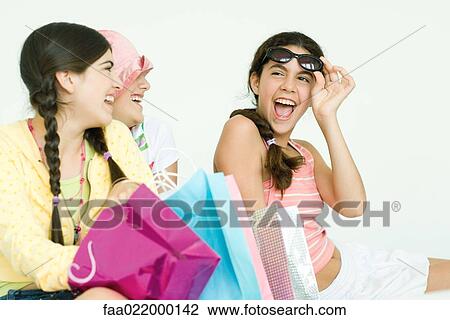 Three young female friends with gift bags View Large Photo Image Stock Image - Three young female friends with gift bags. Fotosearch