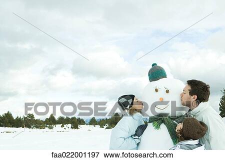 Three young friends kissing snowman, head and shoulders View Large Photo Image Stock Photo - Three young friends kissing snowman, head and shoulders. Fotosearch