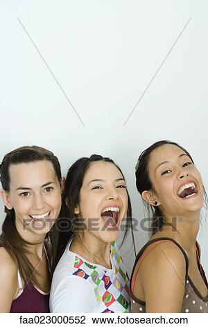 Three young friends laughing together, two looking at camera, portrait View Large Photo Image Stock Image - Three young friends laughing together, two looking at camera, portrait. Fotosearch