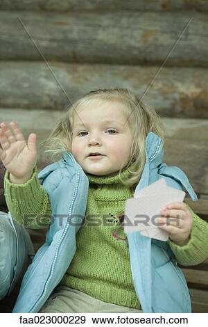 Toddler girl holding cards, motioning with hand View Large Photo Image Stock Photo - Toddler girl holding cards, motioning with hand. Fotosearch