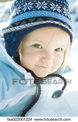 Picture - Toddler girl smiling at camera, dressed in winter clothing, portrait. Fotosearch