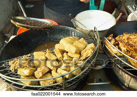Picture - Tofu in wok in outdoor food stand, China. Fotosearch