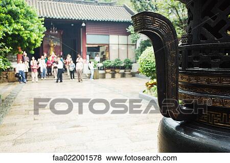 Tourists in temple courtyard, urn in foreground View Large Photo Image Stock Photo - Tourists in temple courtyard, urn in foreground. Fotosearch