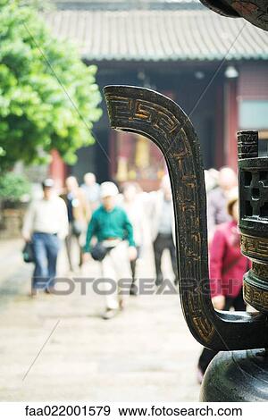 Tourists in temple courtyard, urn in foreground View Large Photo Image Stock Photo - Tourists in temple courtyard, urn in foreground. Fotosearch