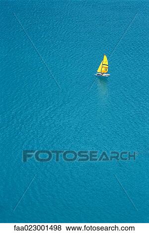 Trimaran sailing in blue sea, aerial view View Large Photo Image Stock Photo - Trimaran sailing in blue sea, aerial view. Fotosearch