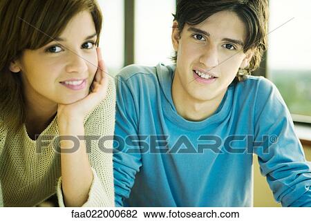 Two college students, smiling at camera, portrait View Large Photo Image Stock Image - Two college students, smiling at camera, portrait. Fotosearch