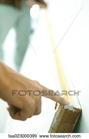 Two people holding measuring tape along length of door turned on its side, close-up of hand View Large Photo Image Stock Photo - Two people holding measuring tape along length of door turned on its side, close-up of hand. Fotosearch