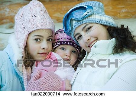 Picture - Two teen girls with toddler, portrait. Fotosearch