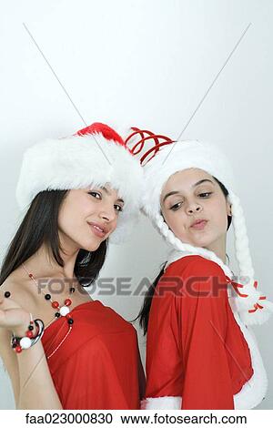 Two young female friends dressed in Christmas costumes, portrait View Large Photo Image Stock Image - Two young female friends dressed in Christmas costumes, portrait. Fotosearch