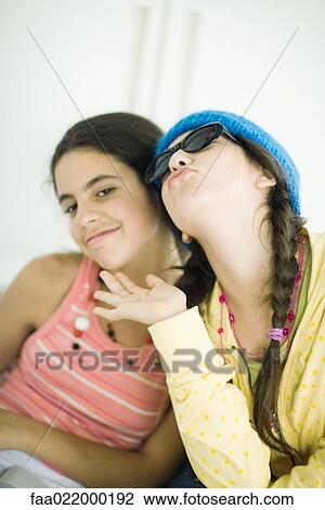 Two young female friends posing, portrait View Large Photo Image Stock Image - Two young female friends posing, portrait. Fotosearch