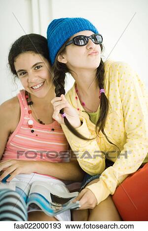 Stock Image - Two young female friends posing, portrait. Fotosearch