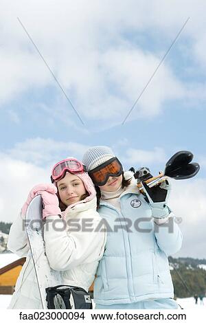 Two young skiers standing together, smiling at camera, portrait View Large Photo Image Picture - Two young skiers standing together, smiling at camera, portrait. Fotosearch