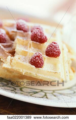 Waffles topped with raspberries and powdered sugar View Large Photo Image Stock Photo - Waffles topped with raspberries and powdered sugar. Fotosearch