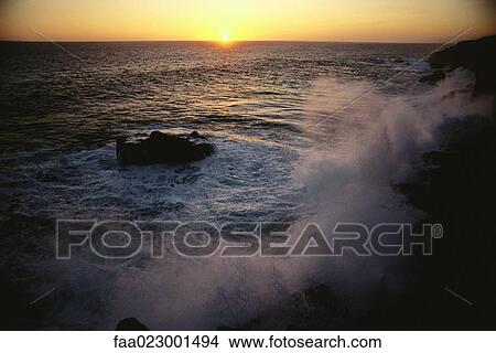 Waves crashing at sunset View Large Photo Image Picture - Waves crashing at sunset. Fotosearch
