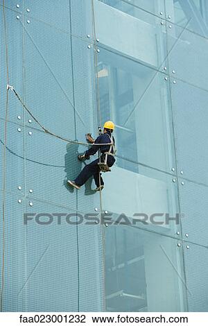 Window washer on side of office building, close-up View Large Photo Image Stock Image - Window washer on side of office building, close-up. Fotosearch