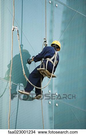 Window washer on side of skyscraper, close-up View Large Photo Image Picture - Window washer on side of skyscraper, close-up. Fotosearch