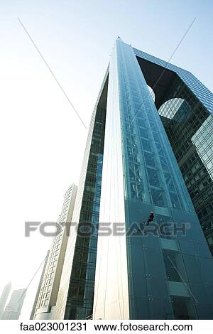 Window washer on side of skyscraper, low angle view View Large Photo Image Stock Image - Window washer on side of skyscraper, low angle view. Fotosearch